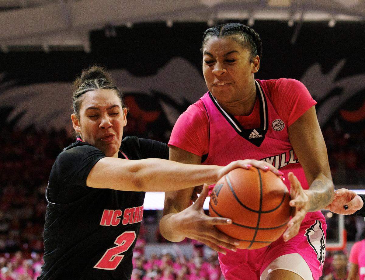 N.C. State’s Mimi Collins and Louisville’s Nyla Harris dive out of bounds during the second half of the Wolfpack’s 77-67 win on Monday, Feb. 5, 2024, at Reynolds Coliseum in Raleigh, N.C.