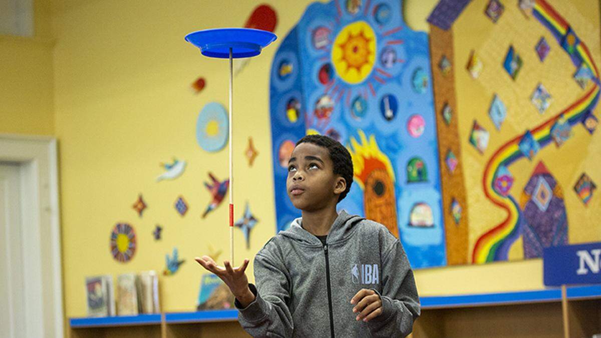 Delreese Glover performs with his spinning plates during the Magnet Theme Showcase at Washington Magnet Elementary School, where parents learn about what the school may offer their child if they are accepted,in this 2020 file photo. Washington was named the top magnet elementary school in the nation in 2023.