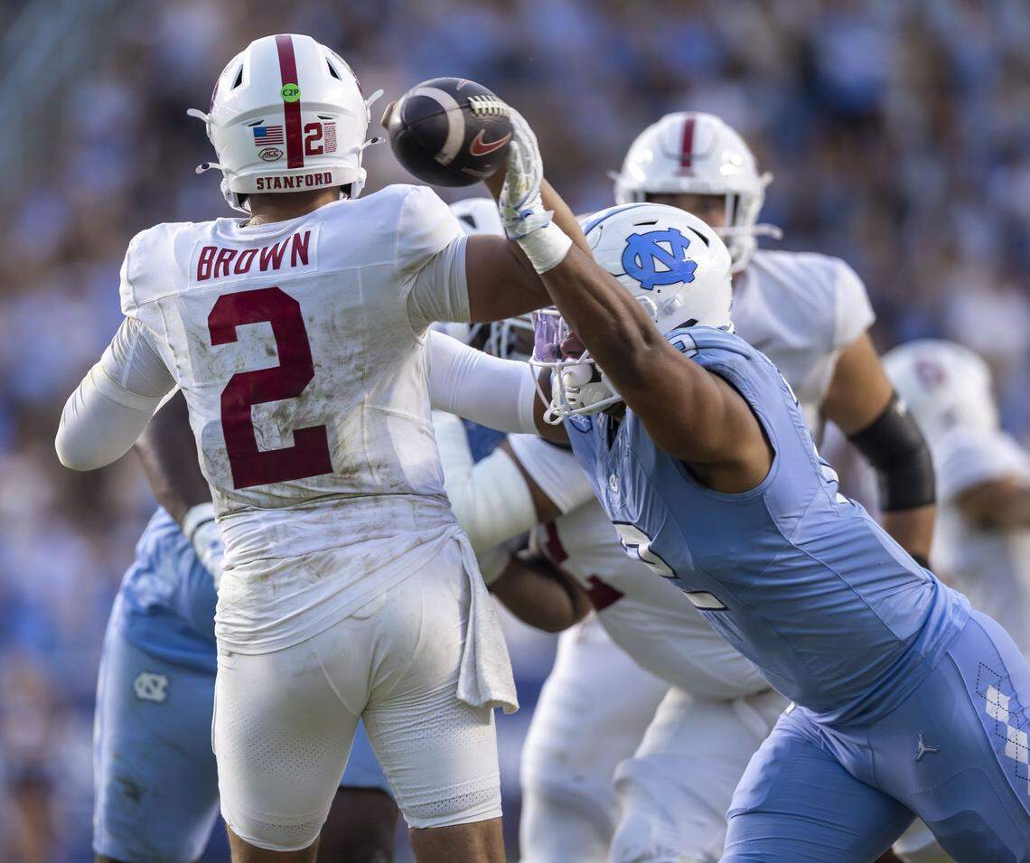 North Carolina linebacker Andrew Simpson (2) forces a fumble by Stanford quarterback Elijah Brown (2) in the first quarter on Saturday, November 8, 2025 at Kenan Stadium in Chapel Hill, N.C.