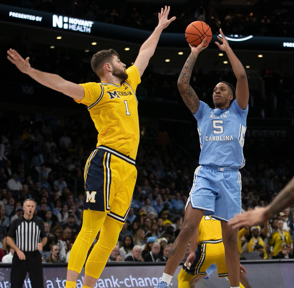 North Carolina’s Armando Bacot (5) puts up a shot against Michigan’s Hunter Dickinson (1) in the second half on Wednesday, December 21, 2022 at the Spectrum Center in Charlotte, N.C. Bacot lead all scores with 26 points.