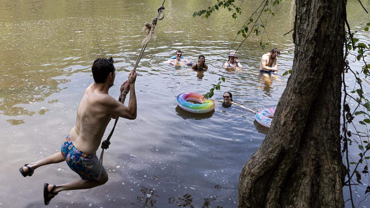 Swimmers play at Sennett’s Hole on the Eno River in Durham in July 2023. This and other popular local swimming holes  may be busy this summer as temperatures are again expected to be above average. 