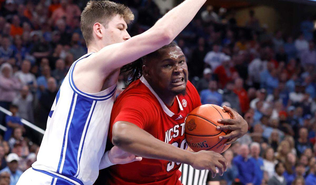 N.C. State’s DJ Burns Jr. (30) gets around Duke’s Kyle Filipowski (30) during the second half of N.C. State’s 74-69 victory over Duke in the quarterfinal round of the 2024 ACC Men’s Basketball Tournament at Capital One Arena in Washington, D.C., Thursday, March 14, 2024.