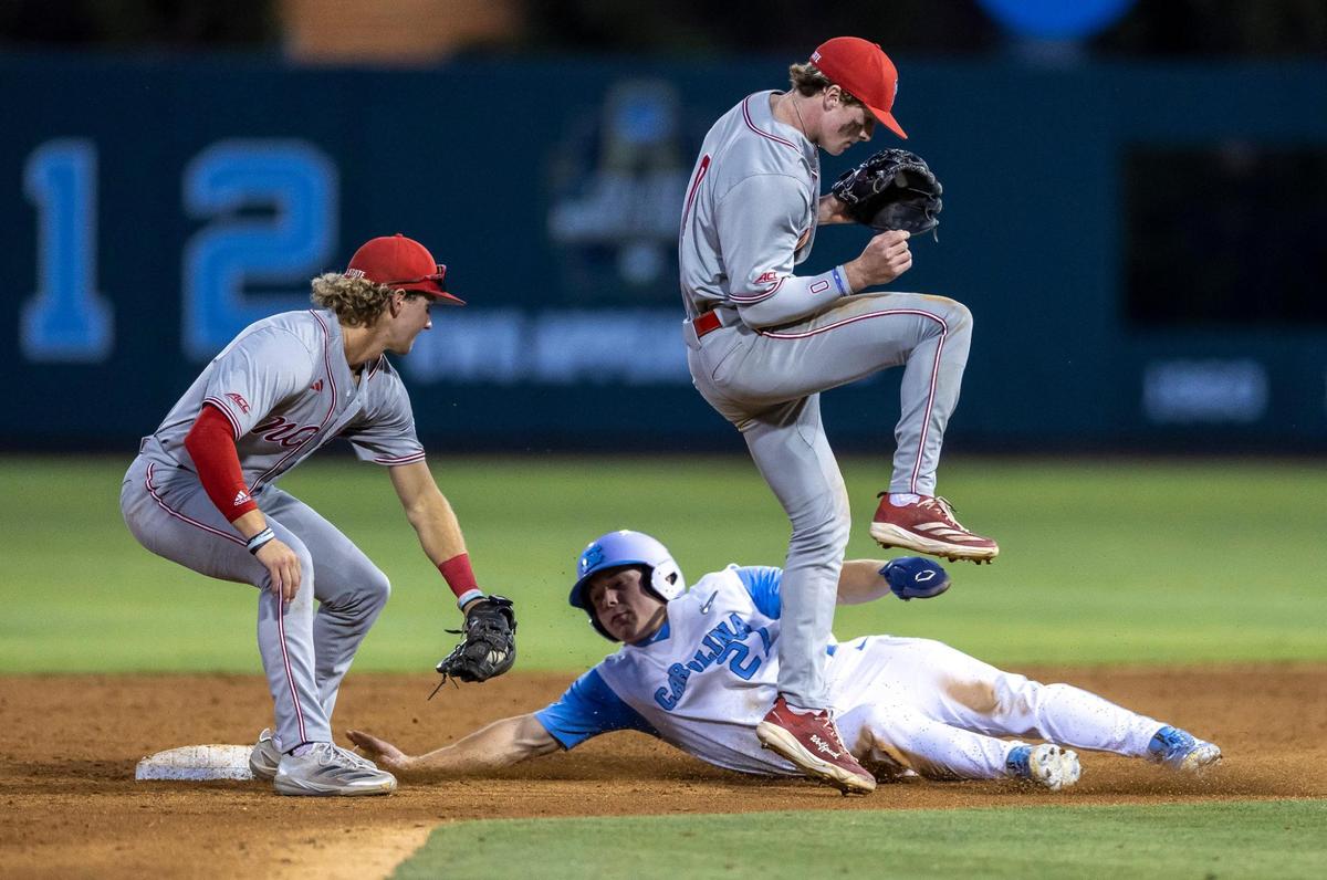 North Carolina outfielder Kane Kepley (27) steals second base under N.C. State short stop Justin DeCriscio (8) and second baseman Luke Nixon (0) in the bottom of the seventh inning on Friday, May 9, 2025 at Boshamer Stadium in Chapel Hill, N.C.