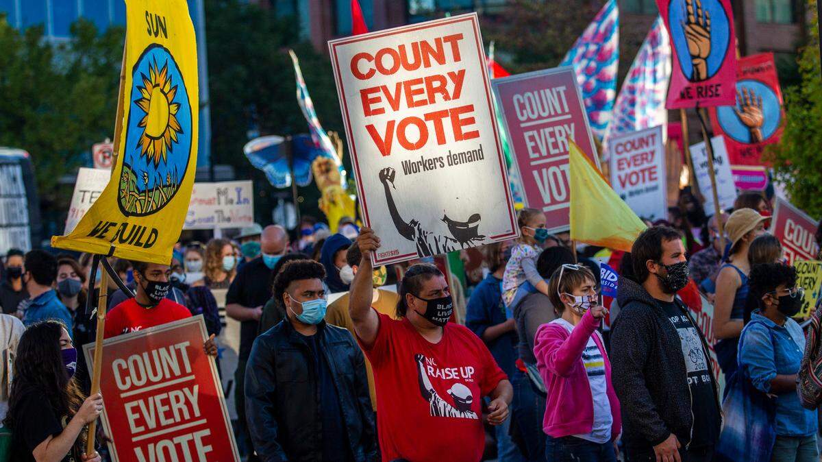 Demonstrators from several community and advocacy groups march in downtown Durham, North Carolina, demanding that all votes cast in Tuesday’s presidential election be counted on Wednesday, Nov. 4, 2020.