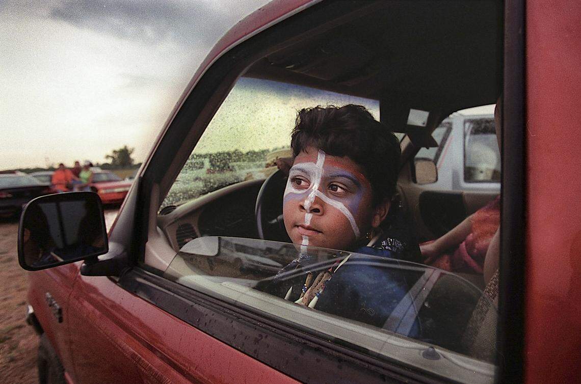 Nicholas Wayne Locklear, 9, sits in the cab of a truck as he waits for a thunderstorm to end at the Lumbee tribe powwow at the farmer’s market grounds in Robeson County . Locklear, who is Lumbee and is from the town of Shannon, was introduced to American Indian dance by his uncle. They were both competing at the powwow.