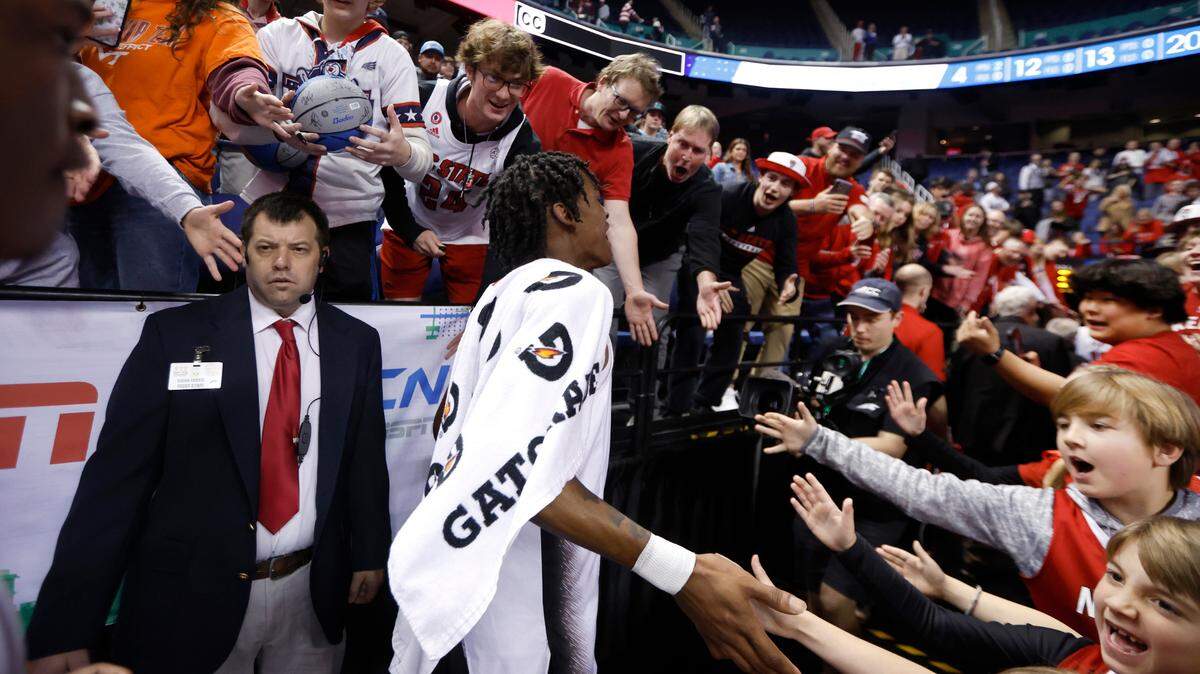 Fans greet N.C. State’s Terquavion Smith (0) as he walks off the court after the Wolfpack’s 97-77 victory over Virginia Tech in the second round of the ACC Men’s Basketball Tournament in Greensboro, N.C., Wednesday, March 8, 2023.