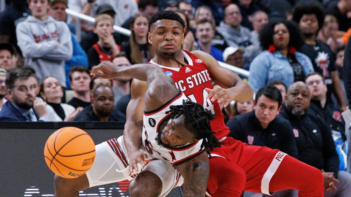 Texas Tech’s Joe Toussaint and N.C. State’s Casey Morsell collide during the second half of the Wolfpack’s 80-67 win in first round of the NCAA Tournament on Thursday, March 21, 2024, at PPG Paints Arena in Pittsburgh, Pa.