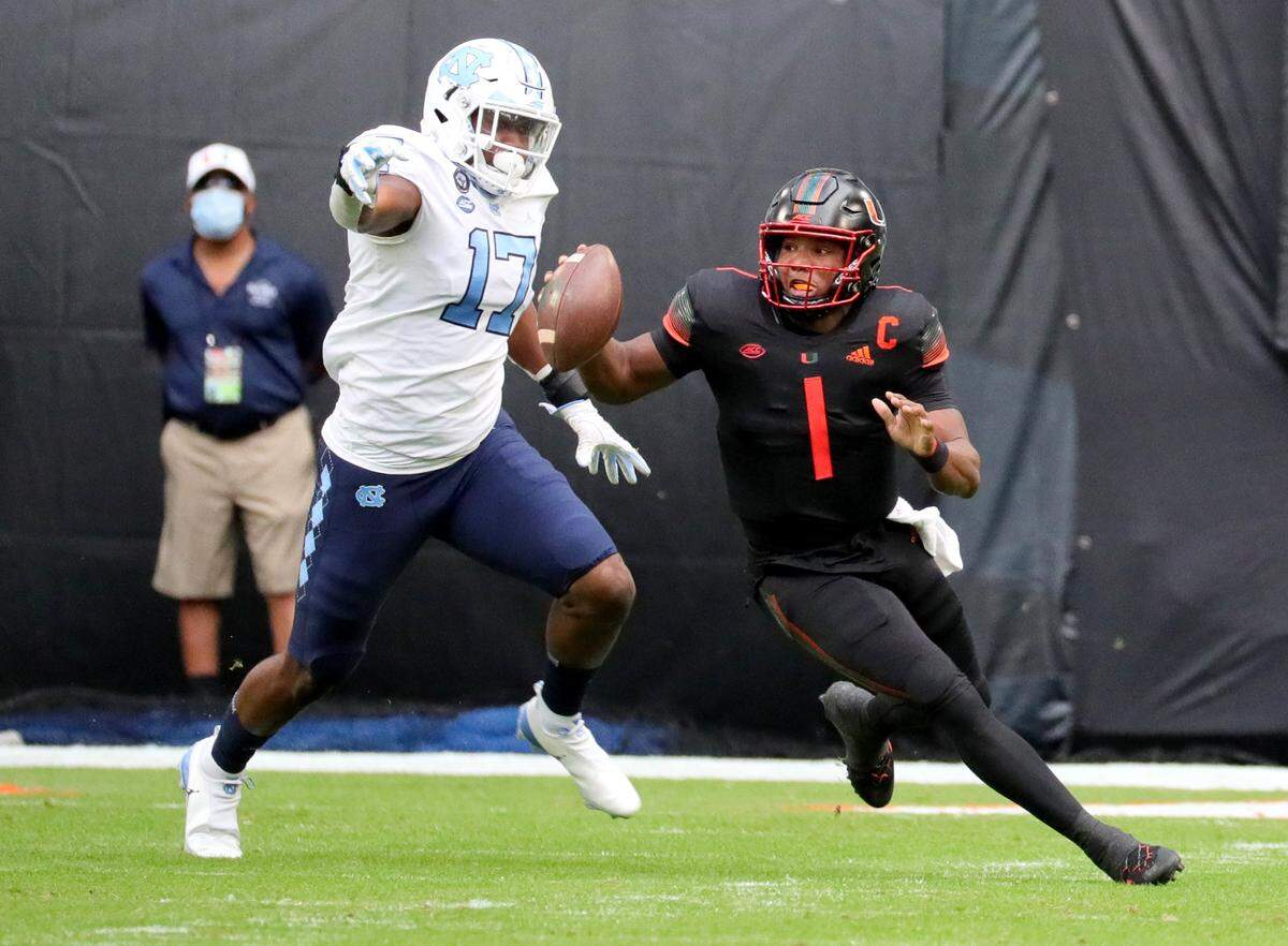 Miami Hurricanes quarterback D’Eriq King (1) is chased by North Carolina Tar Heels linebacker Chris Collins (17) in the first quarter at Hard Rock Stadium In Miami Gardens, Florida, Saturday, December 12, 2020.