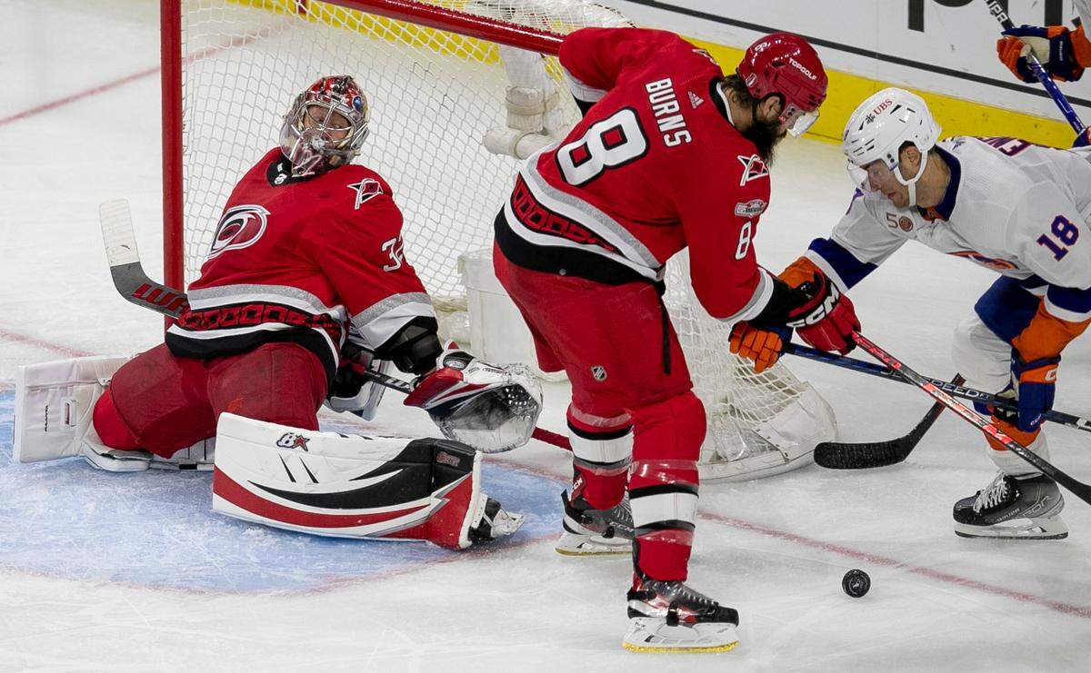 Carolina Hurricanes’ goalie Antii Raanta (32) keeps his eye on the the puck as New York Islanders’ Pierre Engvall (18) works to shoot on a rebound following a save by Raanta in the third period during game two of their Stanley Cup series on Wednesday, April 19, 2023 at PNC Arena in Raleigh, N.C.