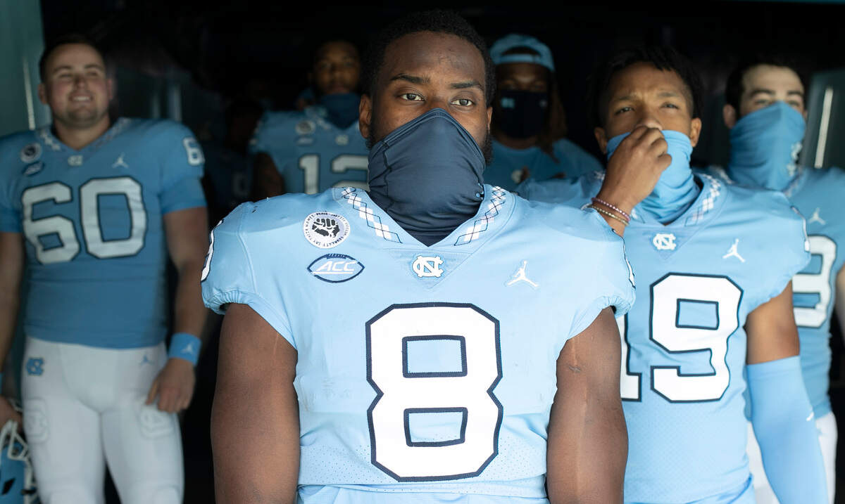 North Carolina’s Michael Carter (8) and fellow seniors wait to enter Kenan Stadium for their final home game on Saturday, December 5, 2020 at Kenan Stadium in Chapel Hill, N.C.