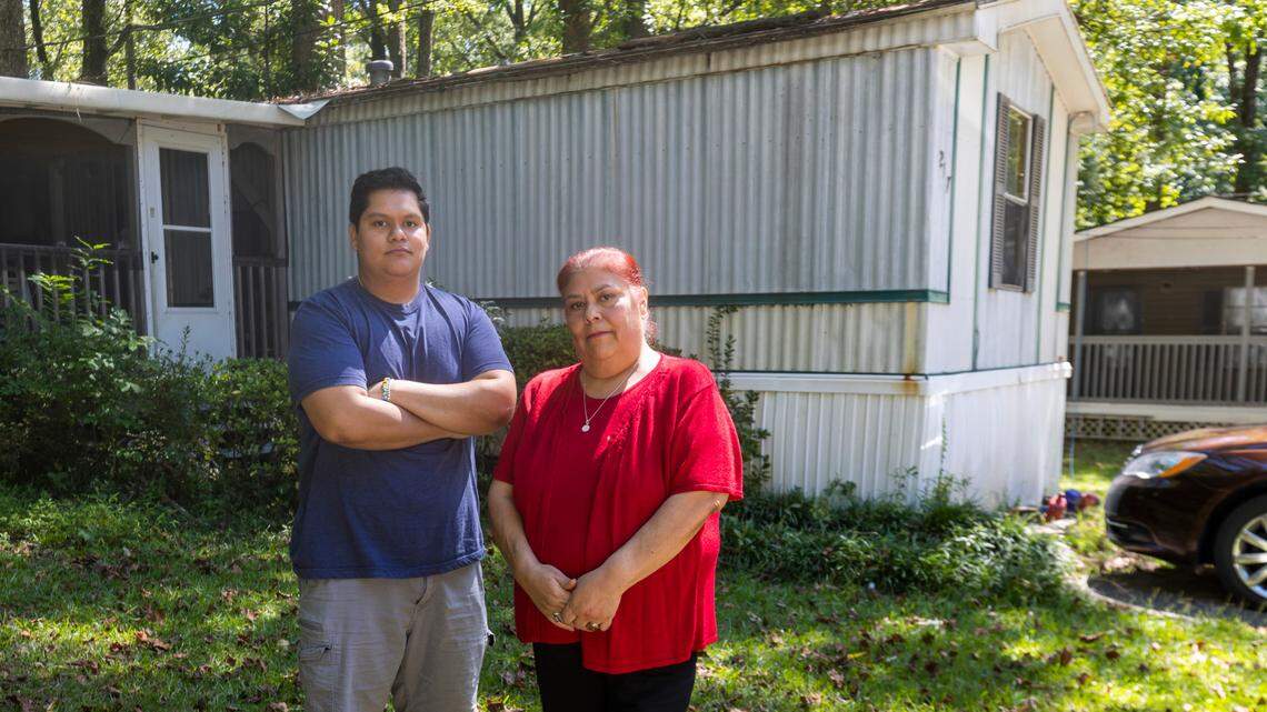 Angelina Zuniga and her son Javier Zuniga in front of their home in the Chatham Estates mobile home park on Friday, September 15, 2023 in Cary, N.C. This is the only home Javier has ever know, now 21-years-old and attending Wake Tech, he is concerned about the possible sale of the park, and where his family can find affordable housing.