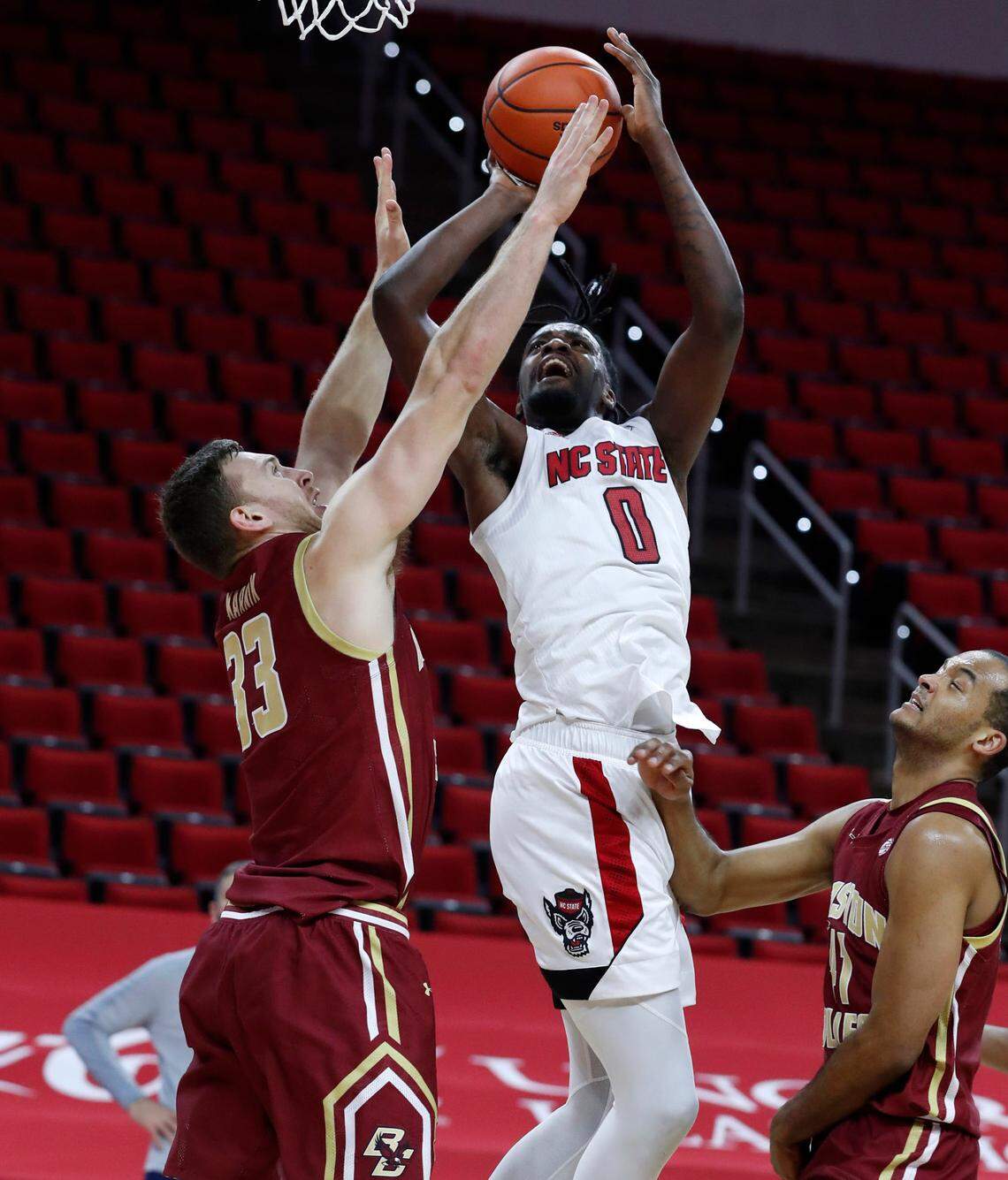 N.C. State’s D.J. Funderburk (0) shoots as Boston College’s James Karnik (33) defends during the first half of N.C. State’s game against Boston College at PNC Arena in Raleigh, N.C., Wednesday, December 30, 2020.