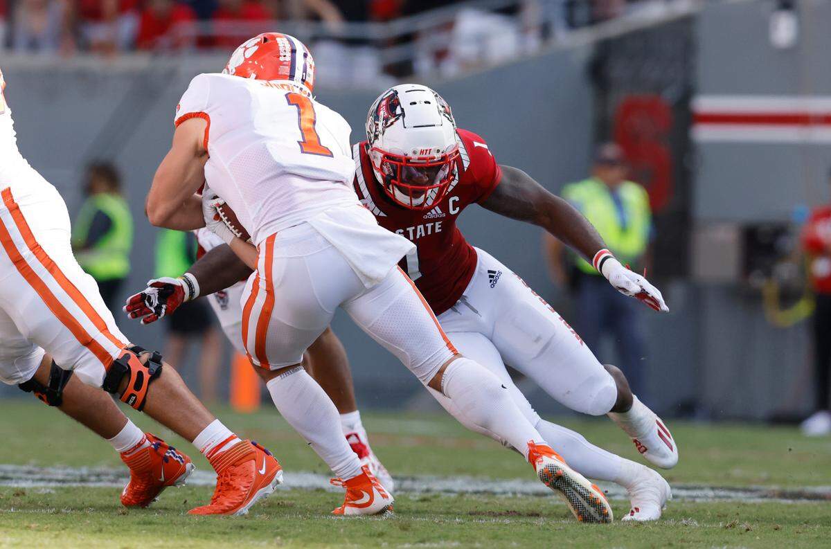 N.C. State linebacker Isaiah Moore (1) tackles Clemson running back Will Shipley (1) during the first half of N.C. State’s game against Clemson at Carter-Finley Stadium in Raleigh, N.C., Saturday, Sept. 25, 2021.