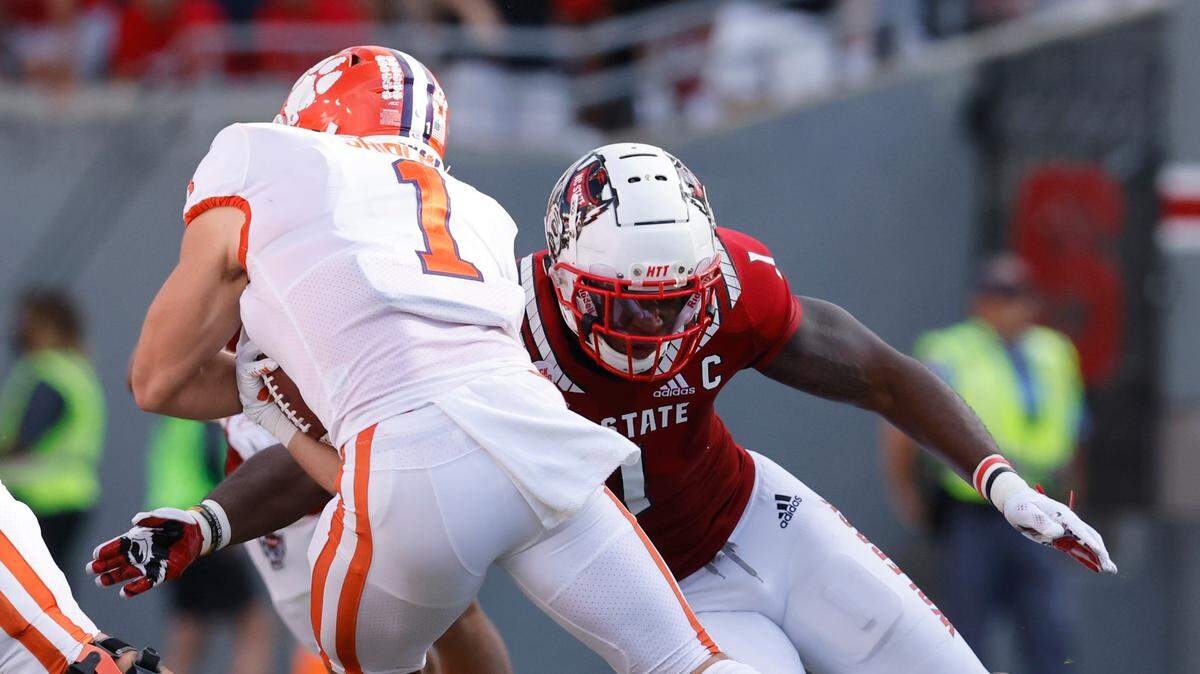 N.C. State linebacker Isaiah Moore (1) tackles Clemson running back Will Shipley (1) during the first half of N.C. State’s game against Clemson at Carter-Finley Stadium in Raleigh, N.C., Saturday, Sept. 25, 2021.