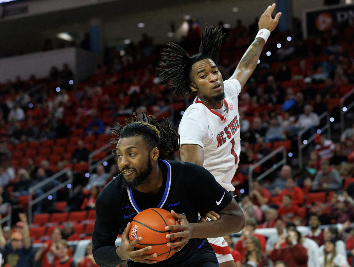 Saint Louis’ Terrence Hargrove Jr. pulls down a rebound in front of N.C. State’s Jayden Taylor during the first half of the Wolfpack’s game on Wednesday, Dec. 20, 2023, at PNC Arena in Raleigh, N.C.