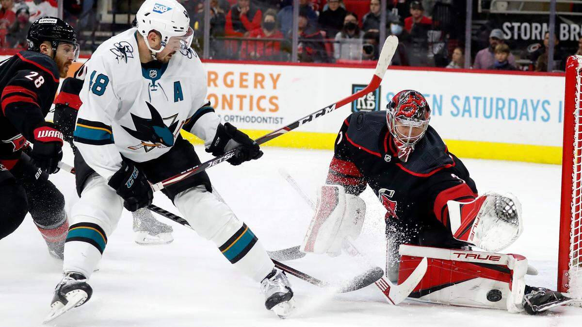 Carolina Hurricanes goaltender Frederik Andersen, right, blocks the shot of San Jose Sharks’ Tomas Hertl (48) during the first period of an NHL hockey game in Raleigh, N.C., Sunday, Jan. 30, 2022. (AP Photo/Karl B DeBlaker)