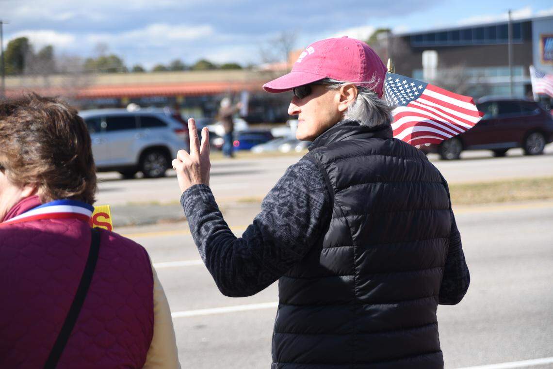 Betty Parker flashes a Peace sign during an Anti-ICE protest in Raleigh Sunday afternoon.