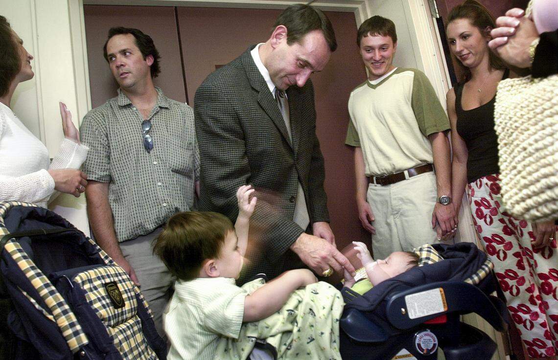 Duke men’s basketball coach Mike Krzyzewski greets his grandson’s Joey, left, and Michael Savarino after a news conference announcing his induction into the Naismith Memorial Basketball Hall of Fame in 2001.