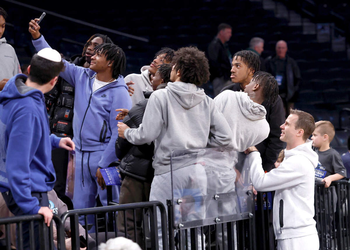 Duke head coach Jon Scheyer poses for a photo with fans during Duke’s practice at the Barclays Center in Brooklyn, N.Y., Thursday, March 21, 2024. The Blue Devils face Vermont in the first round of the NCAA Tournament Friday.