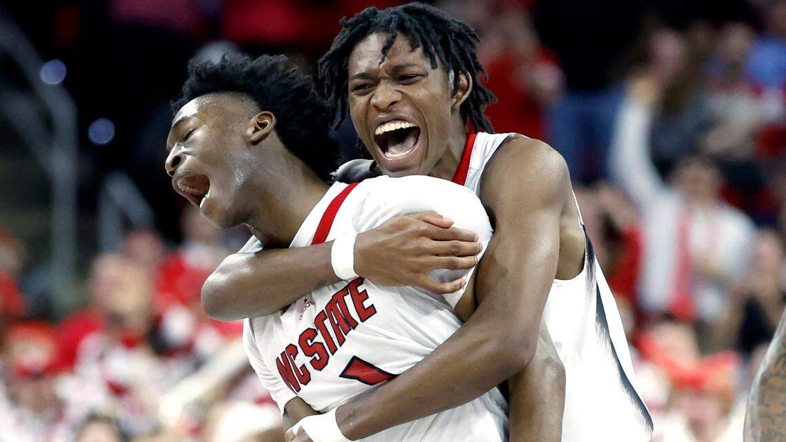 N.C. State’s Terquavion Smith (0) celebrates with Jarkel Joiner (1) during the second half of N.C. State’s 77-69 victory over UNC at PNC Arena in Raleigh, N.C., Sunday, Feb. 19, 2023.