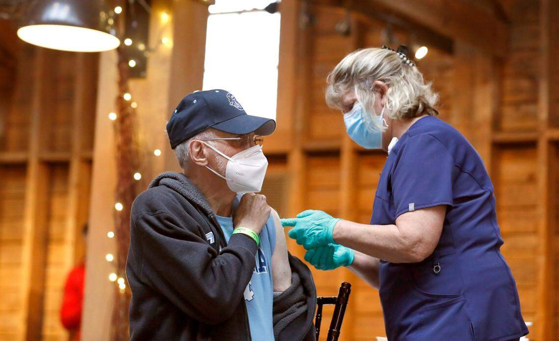 Robert Lanning of Carthage prepares to get his vaccine shot, administered by Wanda Steele, RN, during a COVID-19 vaccination clinic administered by FirstHealth of the Carolinas at the Fair Barn in Pinehurst, N.C., Tuesday, January 26, 2021.