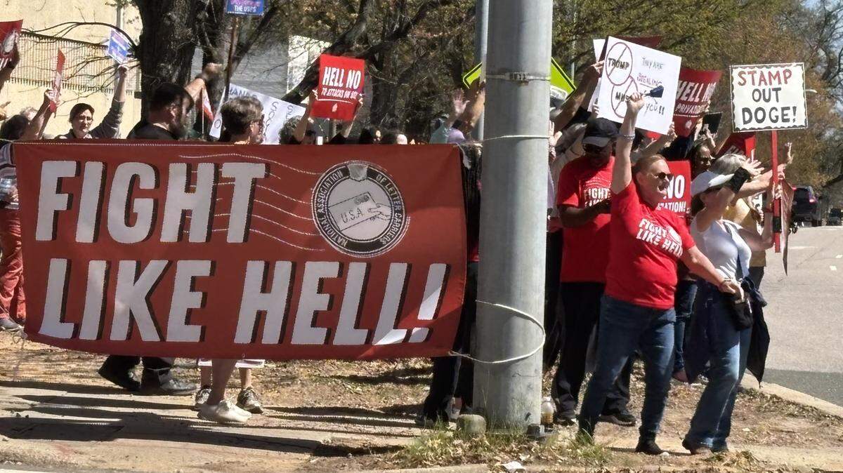 Protesters against plans to privatize the U.S. Postal Service at the corner of New Bern Avenue and Person Street on Sunday. The National Association of Letter Carriers sponsored the protest, one of many across the country.