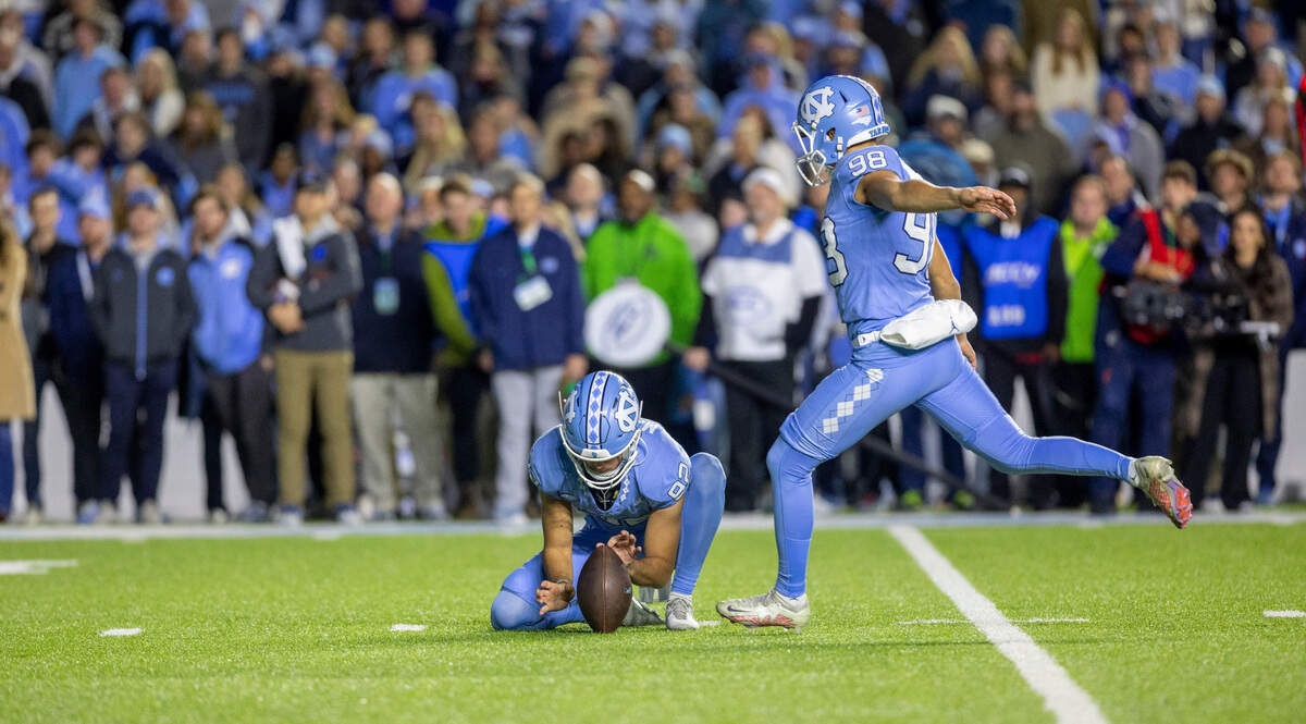 North Carolina kicker Noah Burnette (98) boots a 24-yard field goal to tie Duke 39-39 in the first overtime on Saturday, Nov. 11, 2023 at Kenan Stadium in Chapel Hill, N.C.