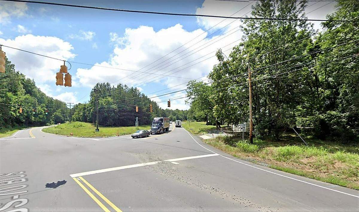 This undeveloped parcel (center left) at the intersection of NC 86 and US 70A in Hillsborough is being developed for a mix of retail, restaurants and office uses. Hillsborough Self-Storage and the Leland Little auction house (at right) are located across the street.