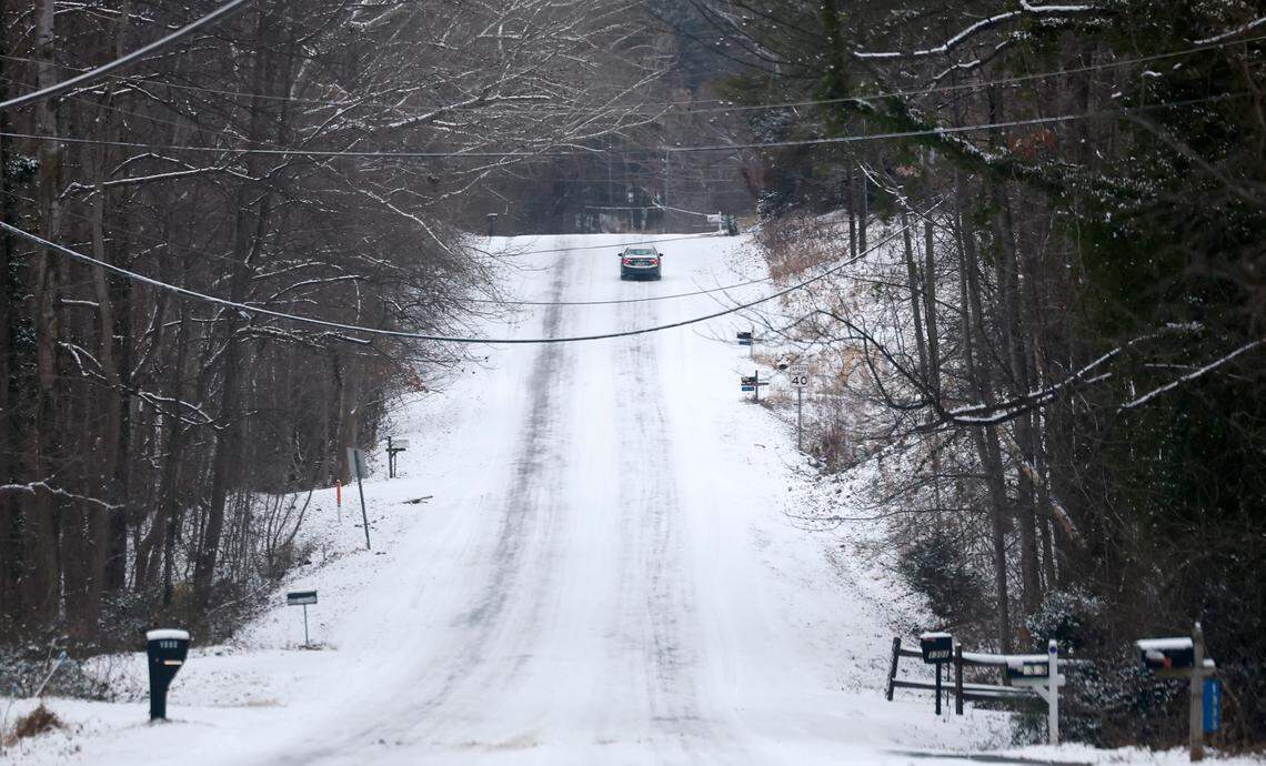 A car navigates Trailwood Drive in Raleigh, N.C., Wednesday morning, Jan. 22, 2025.