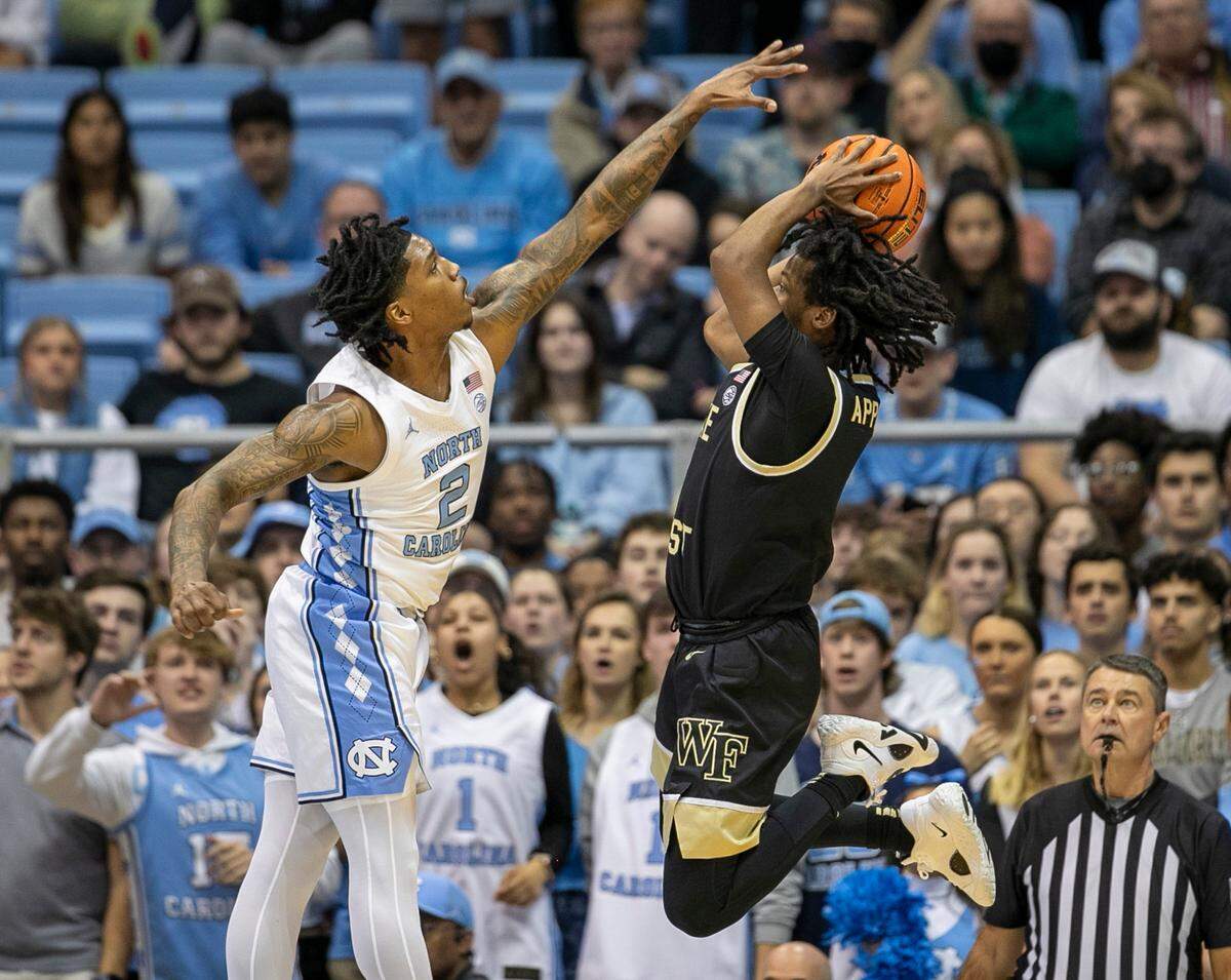 North Carolina’s Caleb Love (2) defends Wake Forest’s Tyree Appleby (1) in the first half on Wednesday, January 4, 2023 at the Smith Center in Chapel Hill, N.C.