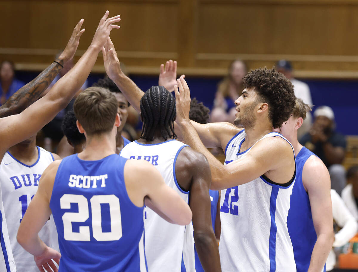 Duke’s Cameron Boozer (12) high-fives with teammates during the Blue Devils’ open practice at Cameron Indoor Stadium in Durham, N.C., Tuesday, August 5, 2025.