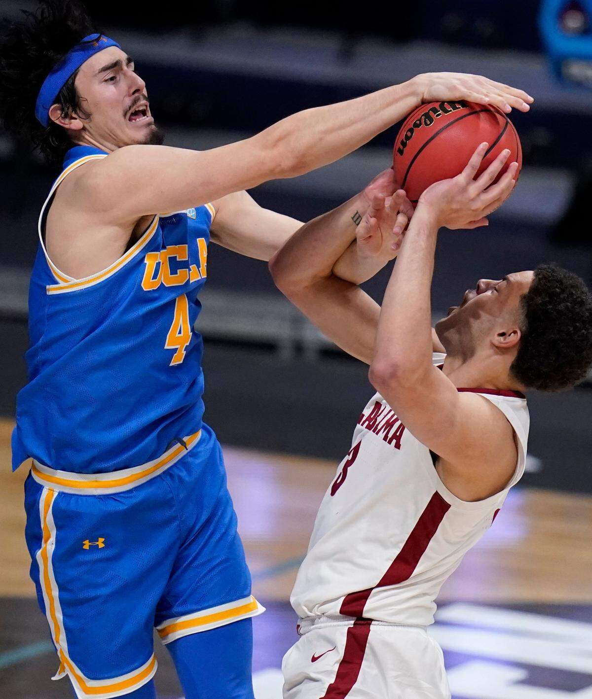 UCLA guard Jaime Jaquez Jr. (4) blocks Alabama forward Alex Reese (3) in overtime of a Sweet 16 game in the NCAA men’s college basketball tournament at Hinkle Fieldhouse in Indianapolis, Sunday, March 28, 2021. 