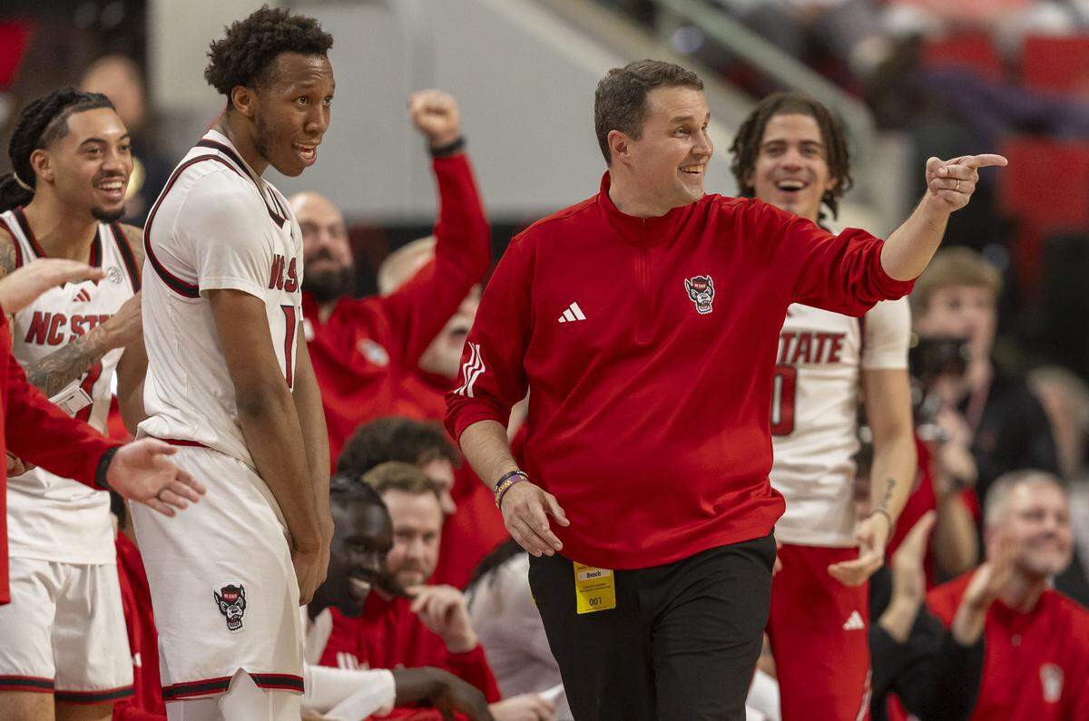 Smiles all around, as N.C. State coach Will Wade takes his starters, including leading scorer Quadir Copeland (11), out of the game, in the closing minutes of play against North Carolina on Tuesday, February 17, 2026 at Lenovo Center in Raleigh, N.C.