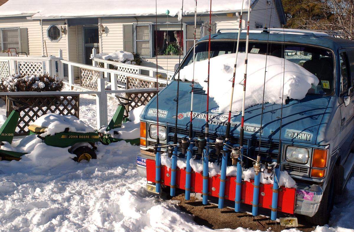 In the fishing village of Wanchese, several inches of snow blanket Gordon Pratt’s home and yard, including his van which is equipped with a host of fishing poles in January 2003.