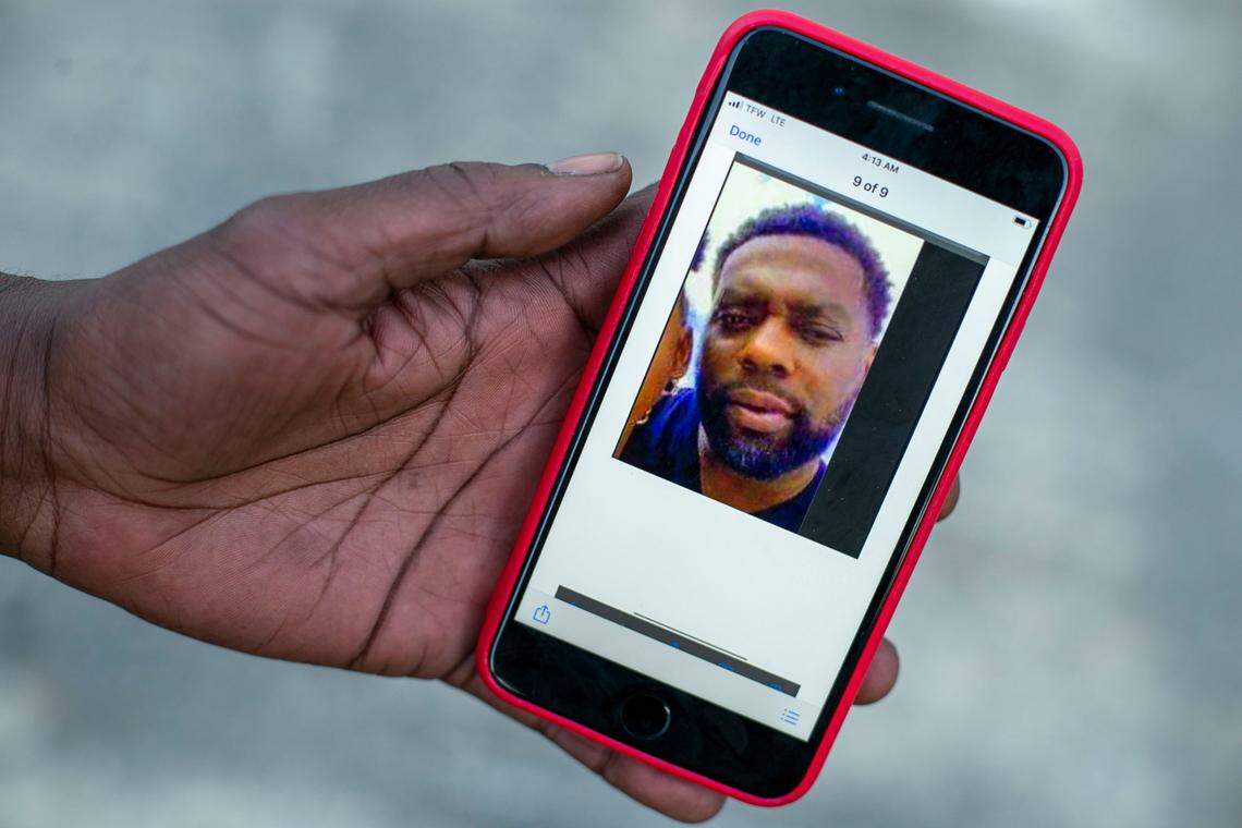 Ulysses Edwards uses an image of Andrew Brown from his phone as the paints a mural on the side of Brown’s Perry Street home on Friday, April 30, 2021 in Elizabeth City, N.C. Edwards went to school with Brown, and is a local tattoo artist who was asked by the landlord of the home to paint the mural.