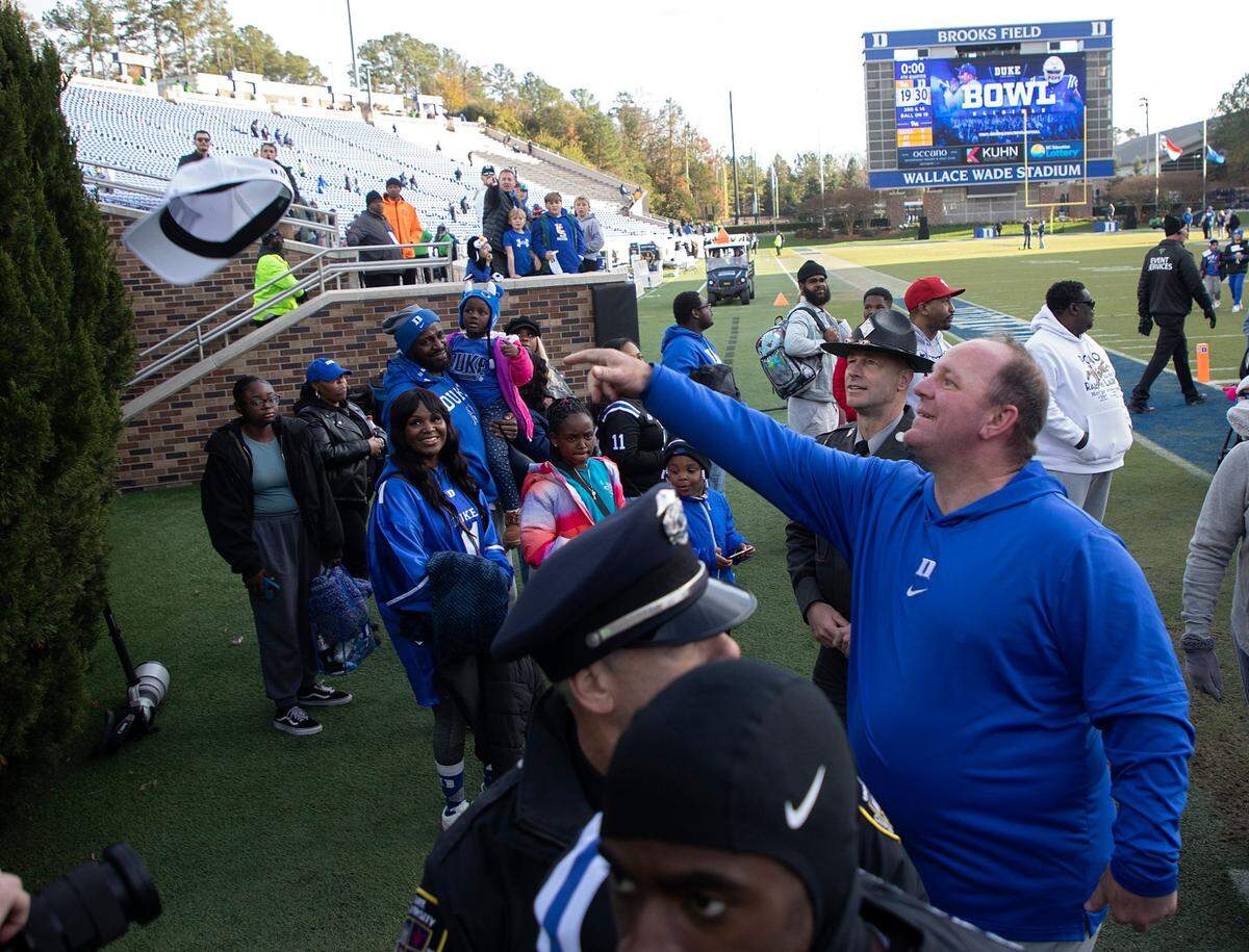 Duke head coach Mike Elko tosses his hat into the crowd following the Blue Devils’ 30-19 win over Pittsburgh on Saturday, Nov. 25, 2023, at Wallace Wade Stadium in Durham, N.C.