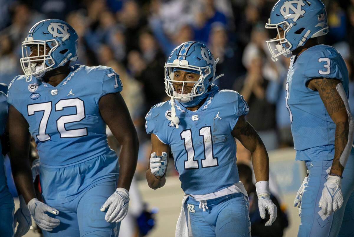 North Carolina’s Josh Downs (11) reacts after scoring on a 13-yard pass reception from quarterback Drake Maye in the third quarter against Pitt on Saturday, October 29, 2022 at Kenan Stadium in Chapel Hill, N.C.