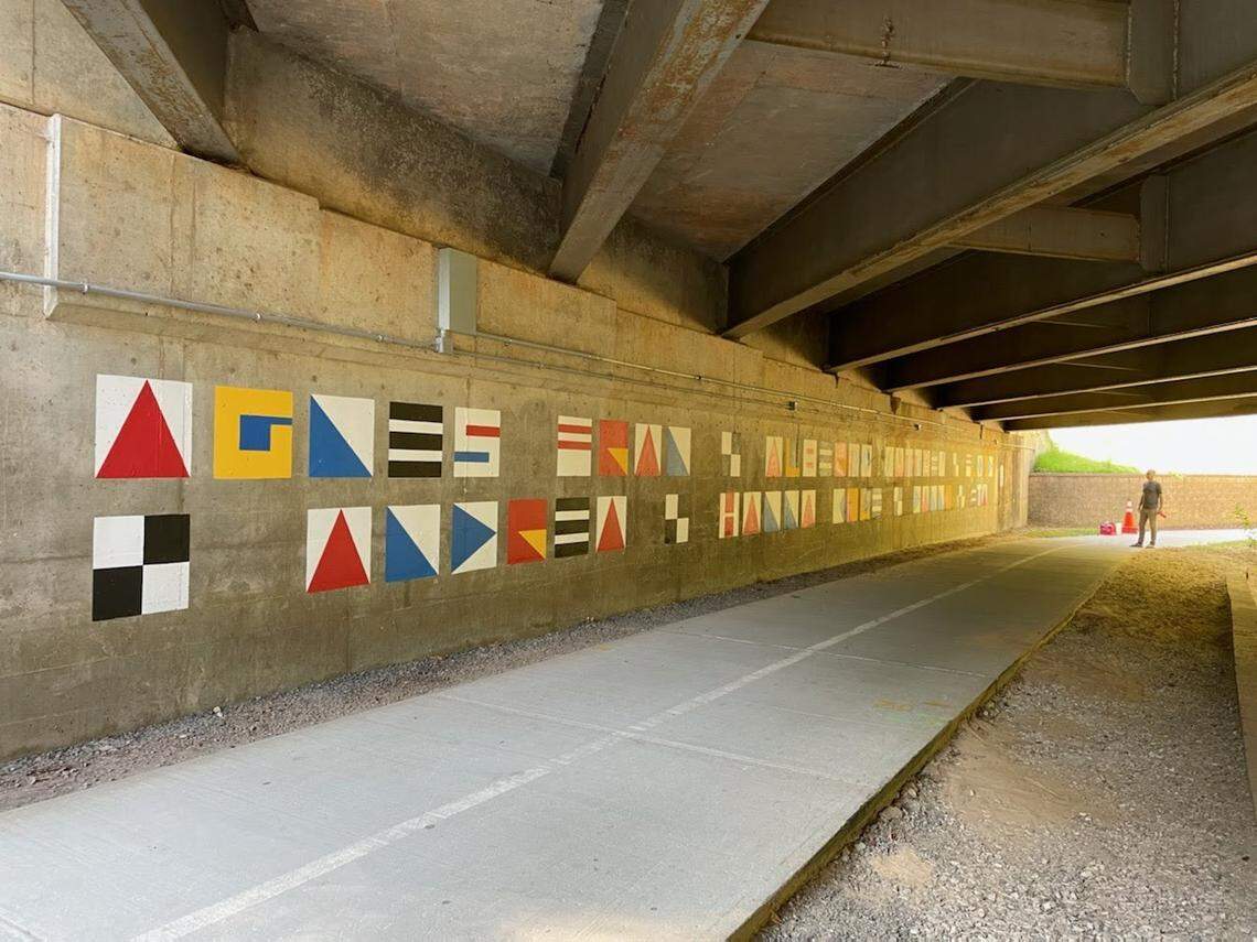 William Dodge, a member of Raleigh design team “A Gang of Three,” stands in the underpass on Blue Ridge Road, the site of a new city mural. Raleigh artist Luke Buchanan painted the mural, spelling out names of storms and hurricanes that have flooded Raleigh. Buchanan, commissioned by the city to paint it, hopes to raise awareness of how dangerous storms can be.