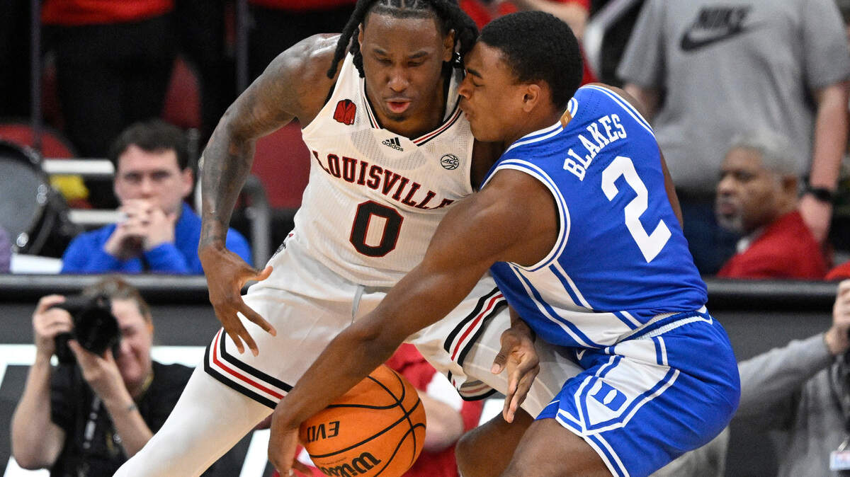 Jan 23, 2024; Louisville, Kentucky, USA; Duke Blue Devils guard Jaylen Blakes (2) steals the ball from Louisville Cardinals guard Mike James (0) during the first half at KFC Yum! Center. Mandatory Credit: Jamie Rhodes-USA TODAY Sports