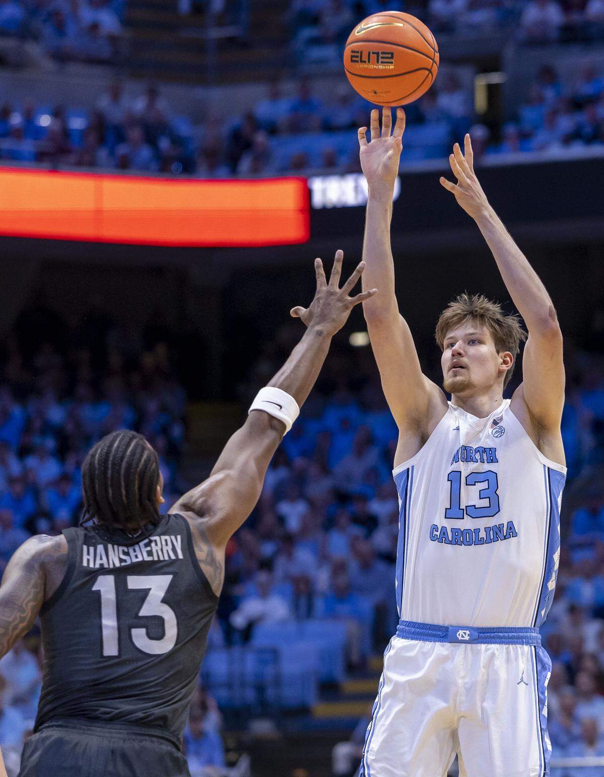 North Carolina center Henri Veesaar (13) puts up a three-point shot against Virginia Tech forward Amani Hansberry (13) in the first half on Saturday, February 28, 2026 at the Smith Center in Chapel Hill, N.C.  Veesaar lead all scores with 26 points. 