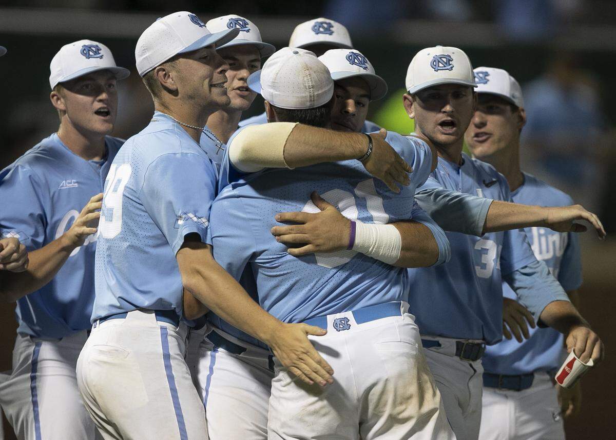 North Carolina closing pitcher Joey Lancellotti (31) is embraced by teammates after the final out against Tennessee clinching the Tar Heels’ 5-2 victory and the NCAA regional championship game on Sunday June 2, 2019 at Boshamer Stadium in Chapel Hill, N.C.