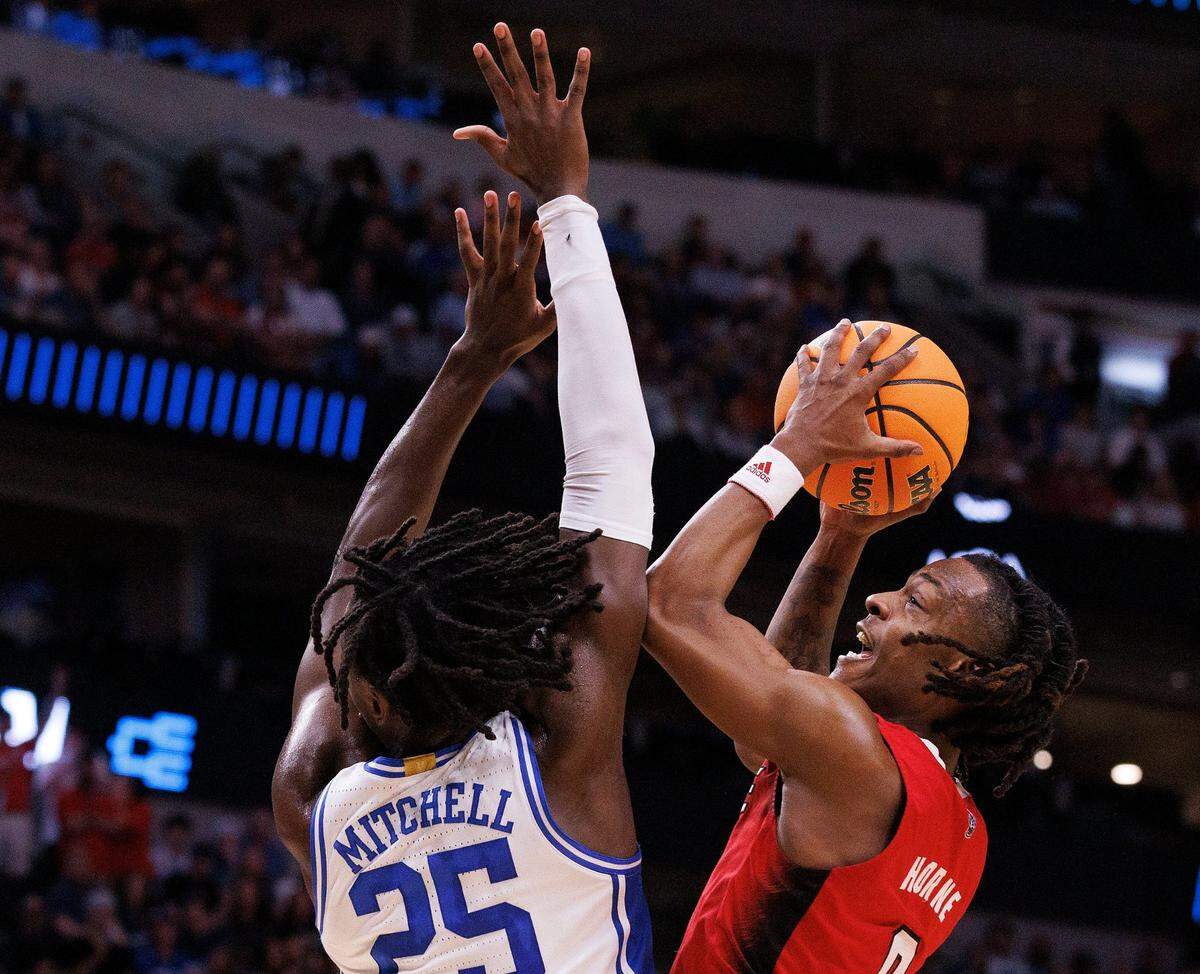 N.C. State’s DJ Horne drives to the basket against Duke’s Mark Mitchell during the first half of the Wolfpack’s NCAA Tournament Elite Eight matchup on Sunday, March 31, 2024, at American Airlines Center in Dallas, Texas.