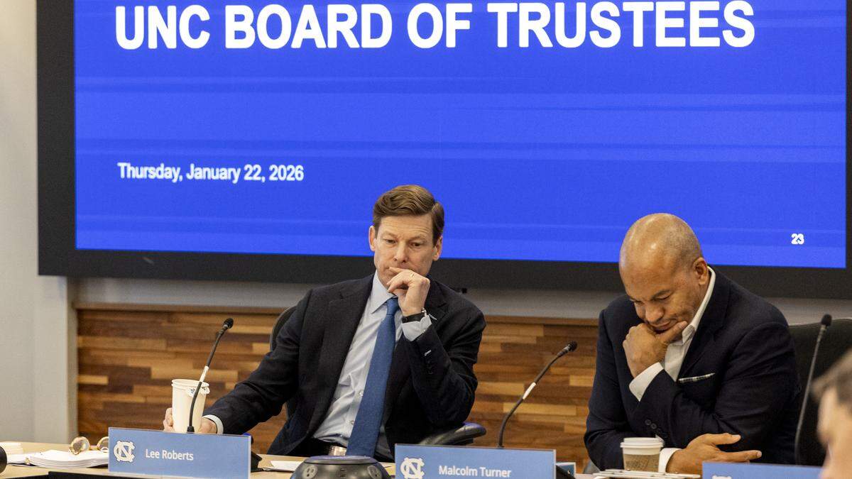 UNC-Chapel Hill Chancellor Lee Roberts, left, and UNC-Chapel Hill Board of Trustees Chair Malcolm Turner preside over the board’s open session meeting at the Spangler Center for Public Health in Chapel Hill on Thursday, Jan. 22, 2026. The board backed a surprise resolution Wednesday to cut $17 million in administrative costs, a proposal that relies in part on layoffs and further cuts to academic centers and institutes.