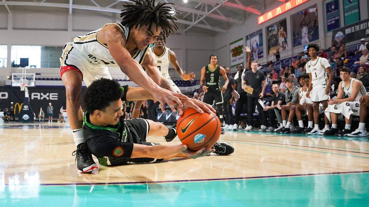 Link Academy Lions guard Elliot Cadeau (3) reaches for the ball during the second quarter of the GEICO High School National championship against the AZ Compass Dragons at Suncoast Credit Union Arena in Fort Myers on Saturday, April 1, 2023.