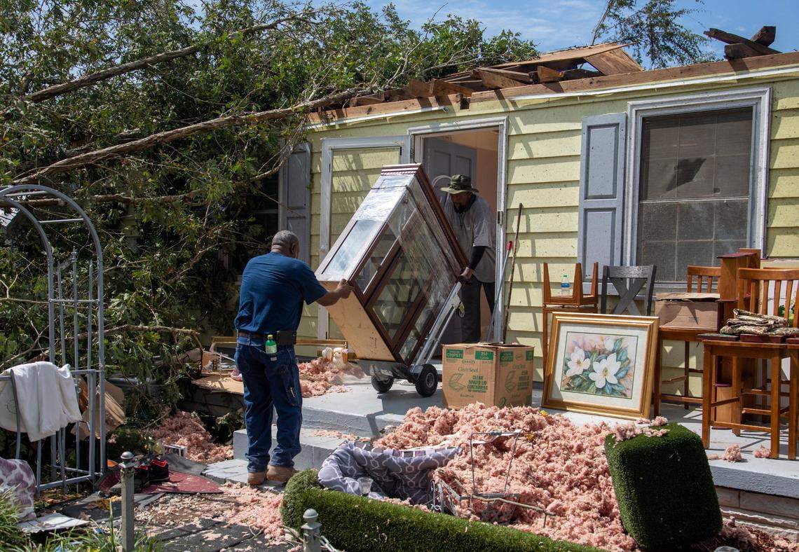 Family members help clean up the home of Evelyn Powell, an Edgecombe County Commissioner, Thursday, July 20, 2023 in Battleboro. An EF3, tornado with wind speeds of 150 mph touched down in Nash and Edgecombe Counties around 12:30 p.m. Wednesday according to the Raleigh National Weather Service.