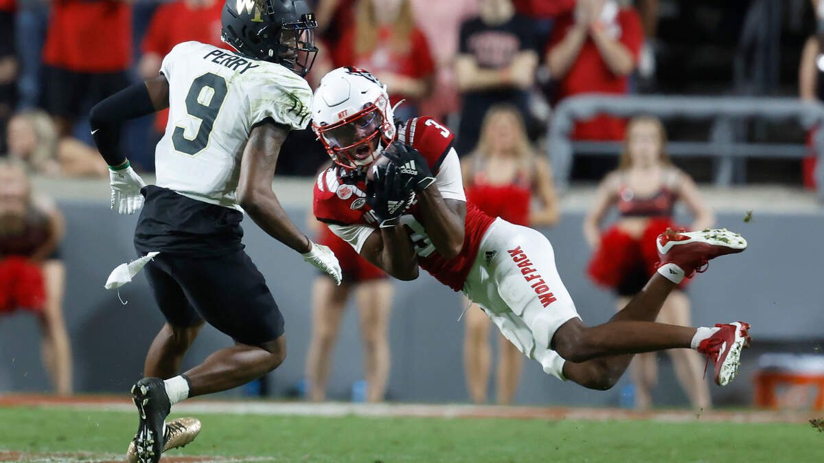 N.C. State’s Aydan White (3) intercepts the ball intended for Wake Forest wide receiver A.T. Perry (9) during the second half of N.C. State’s 30-21 victory over Wake Forest at Carter-Finley Stadium in Raleigh, N.C., Saturday, Nov. 5, 2022.