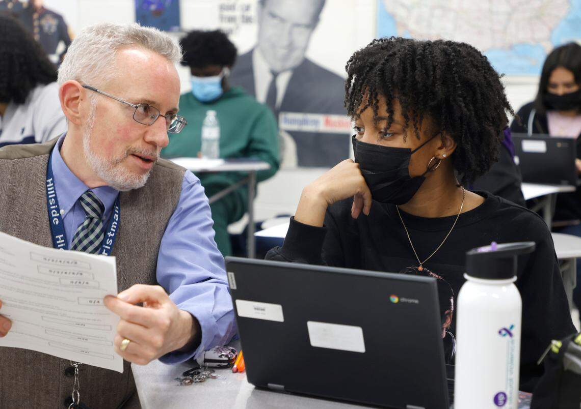 Junior Alysia Davis talks with IB History teacher Alex Christman at Hillside High School in Durham, N.C., Thursday, April 28, 2022.