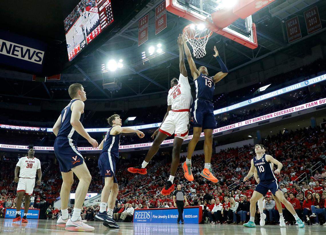 N.C. State’s Mohamed Diarra and Virginia’s Ryan Dunn battle for a rebound during the first half of the Wolfpack’s 76-60 win on Saturday, Jan. 6, 2024, at PNC Arena in Raleigh, N.C.