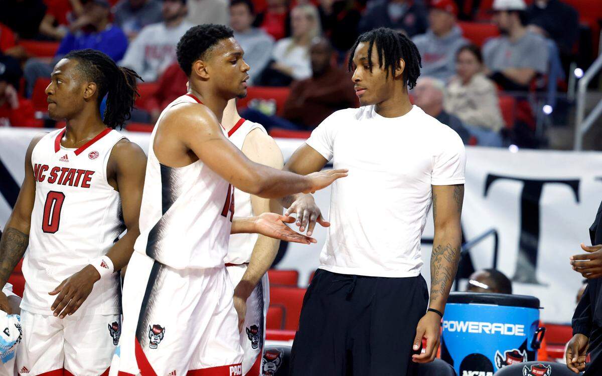 N.C. State’s MJ Rice greets Casey Morsell (14) as he comes off the court in the second half of N.C. State’s 89-76 exhibition victory over Mount Olive at PNC Arena in Raleigh, N.C., Wednesday, Nov. 1, 2023.