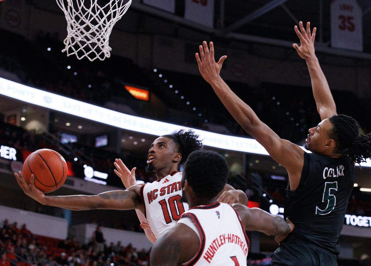N.C. State’s Marcus Hill drives to the basket past William & Mary’s Noah Collier during the second half of the Wolfpack’s 84-61 win at Lenovo Center on Friday, Nov. 22, 2024, in Raleigh, N.C.